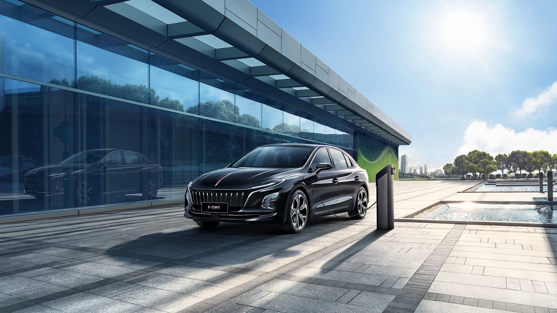 Dark Hongqi E-QM5 beside charging equipment, official model reference image